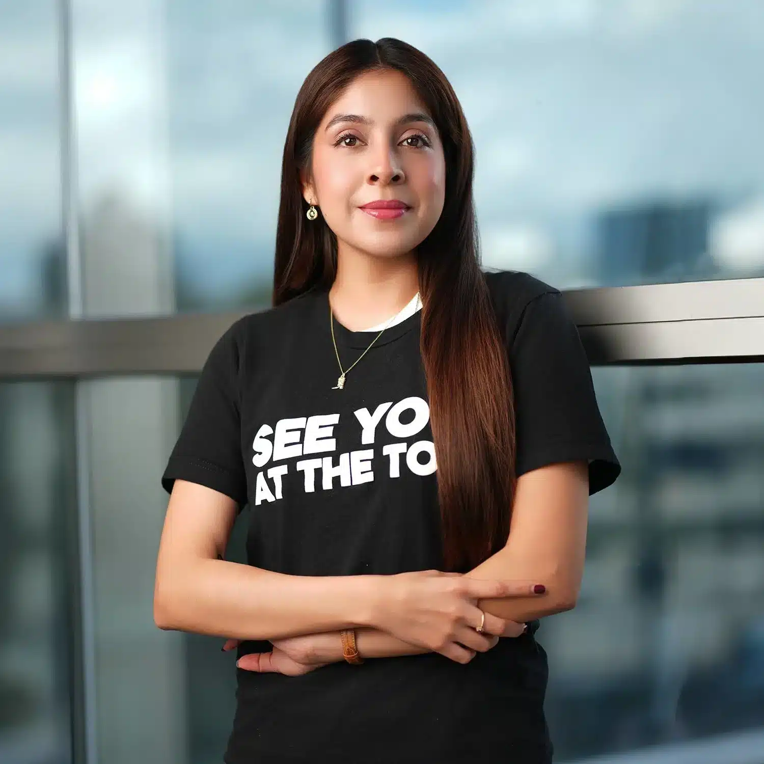 Person in black t-shirt, arms crossed.