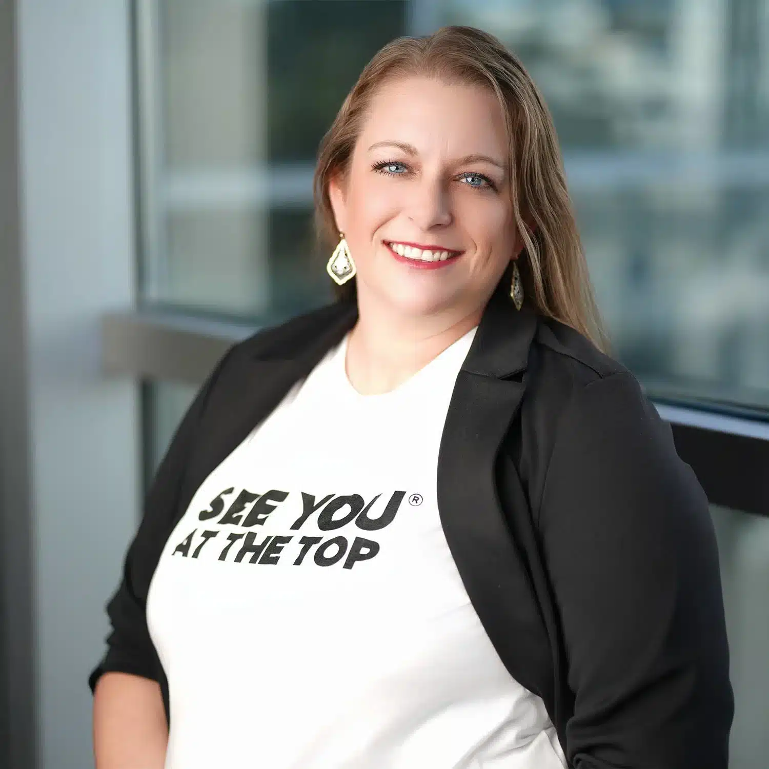 Woman in blazer with motivational shirt.