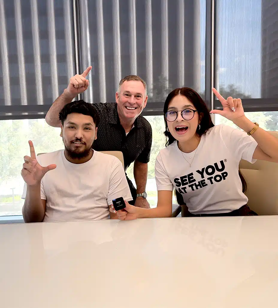 Group celebrating with hand gestures.