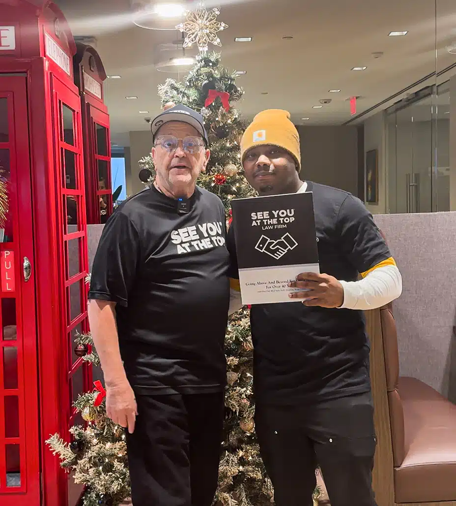 Two people holding a sign.