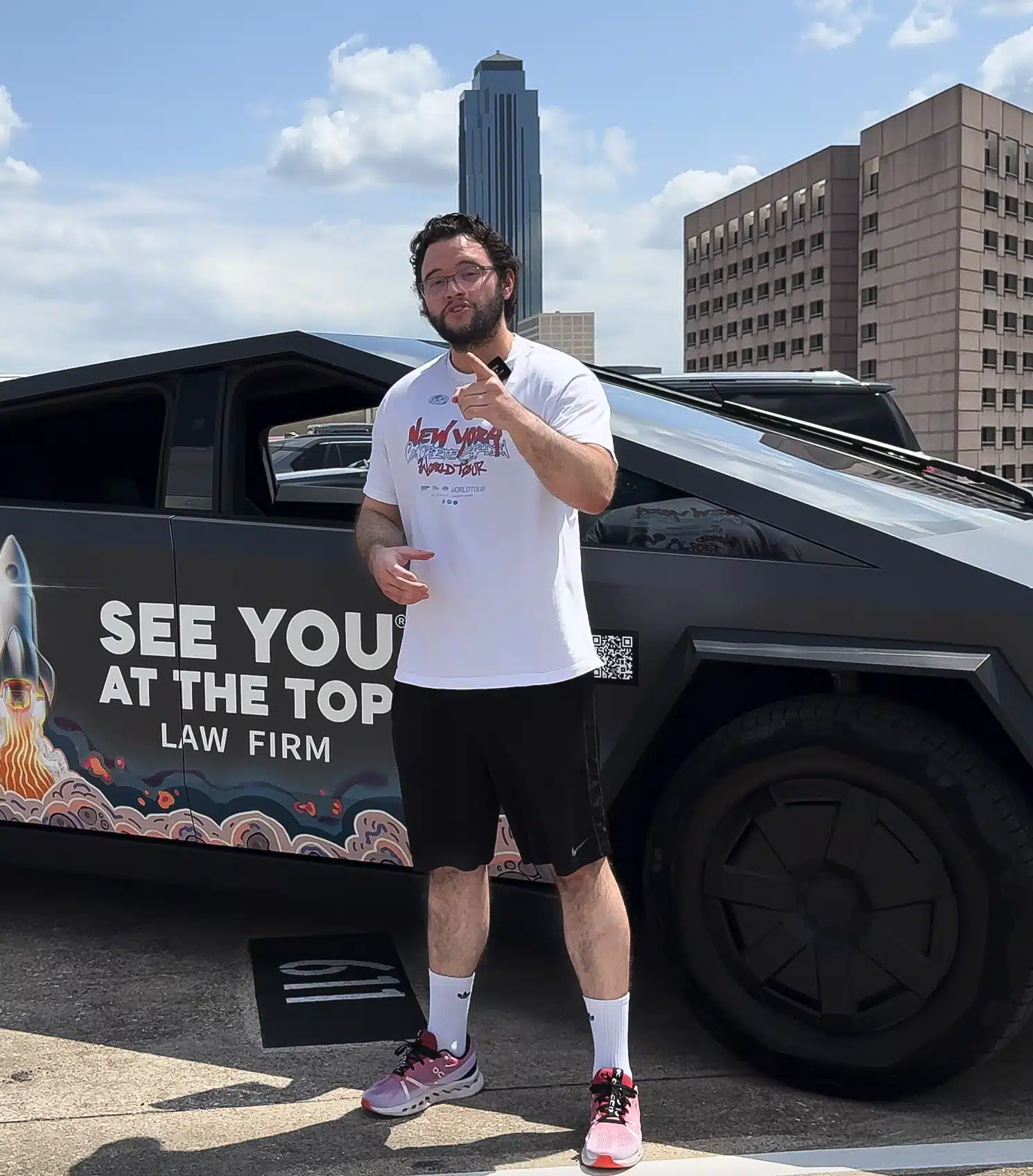 Person posing near futuristic vehicle.