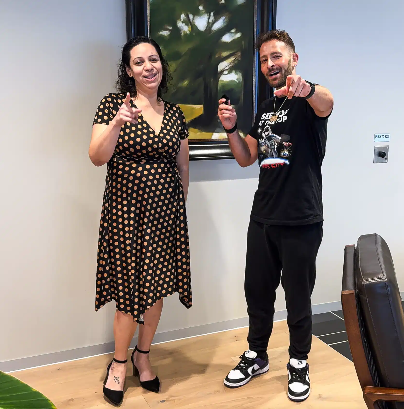 Two people posing indoors, casual attire.